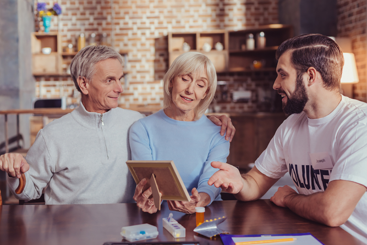 Medicare Insurance - Elderly couple with custodial care worker Medicare Insurance - Elderly couple with custodial care worker