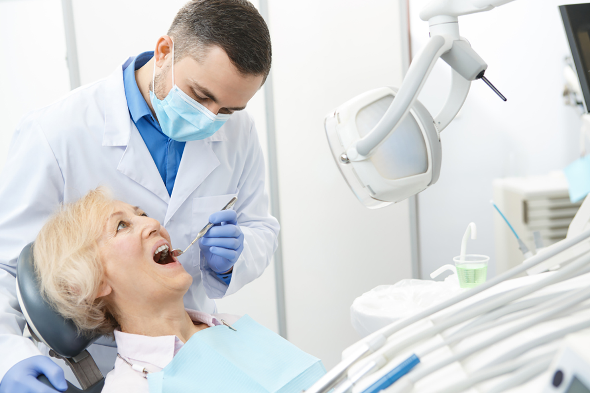 Medicare Insurance - Elderly woman receiving dental care Medicare Insurance - Elderly woman receiving dental care