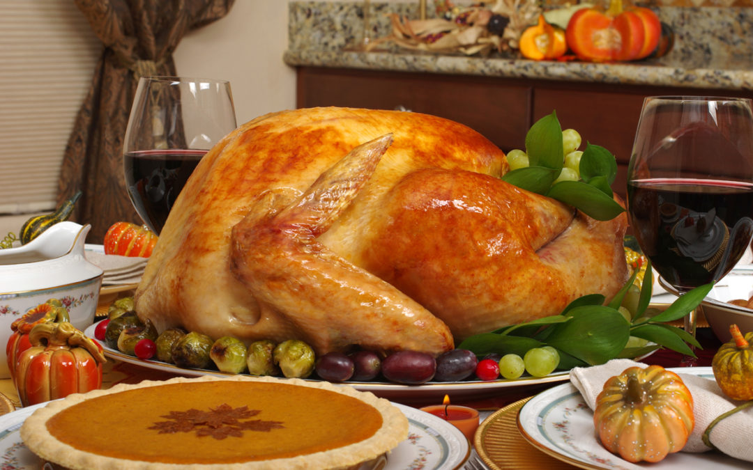 Thanksgiving turkey on table with other holiday dishes